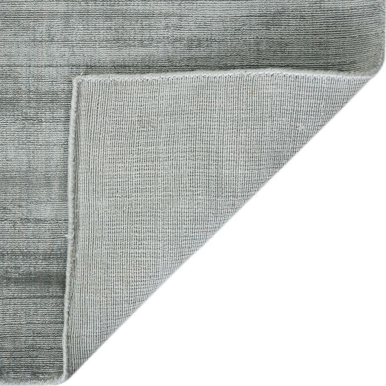 Gray textured rug corner on a white background