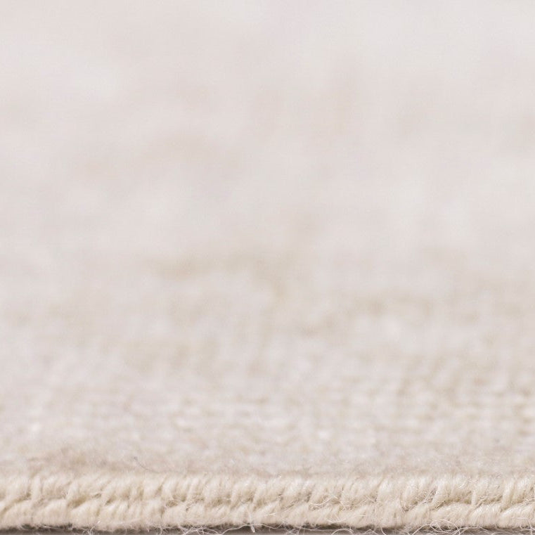 Close-up of a textured beige rug corner