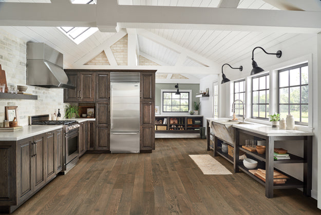 Modern kitchen with wooden cabinets, stainless steel appliances, and large windows.