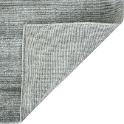Gray textured rug corner on a white background