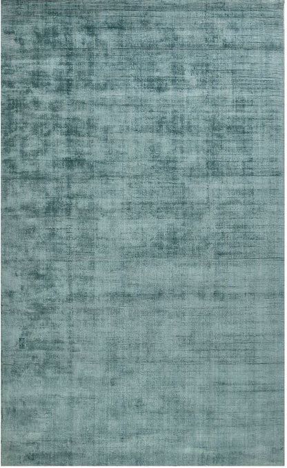 Teal rug with a textured pattern on a white background