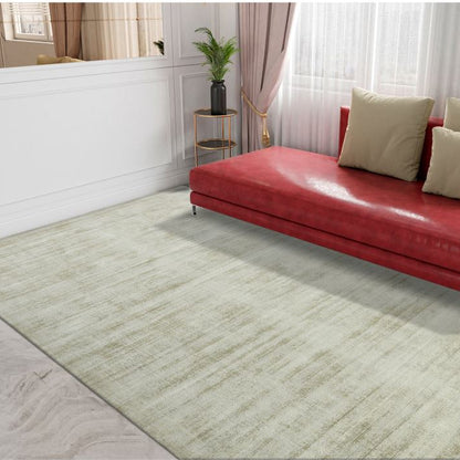 Red sofa with beige cushions on a light green rug in a room with white walls and curtains.