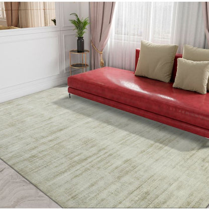 Red sofa with beige cushions on a light green rug in a room with white walls and curtains.