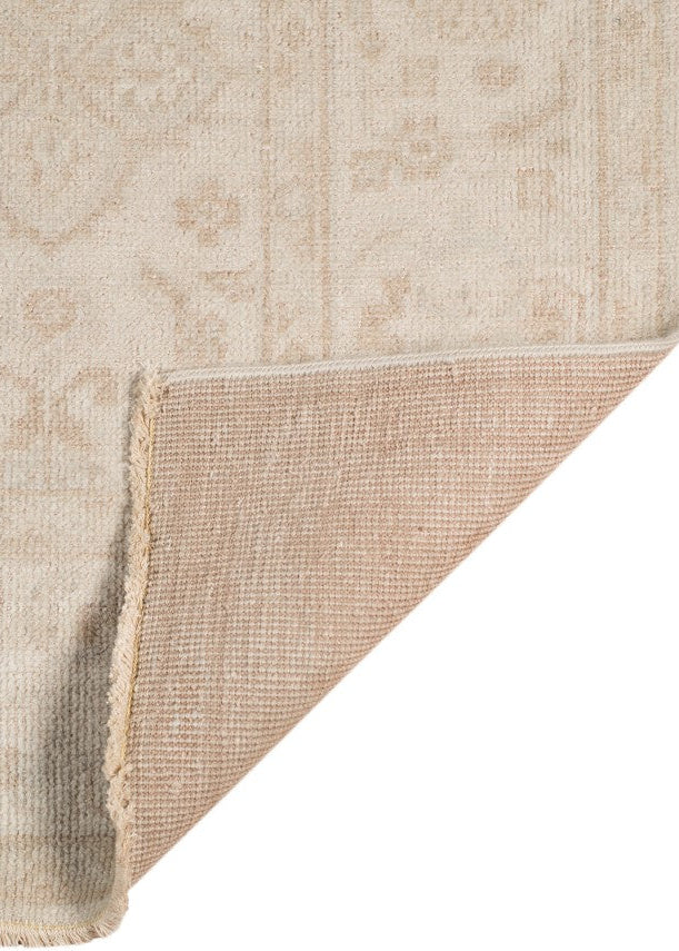 Beige textured rug corner on a white background