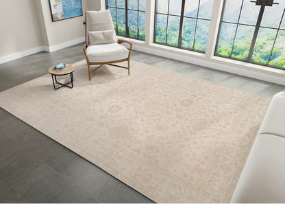 Beige rug in a room with a chair and coffee table near large windows.