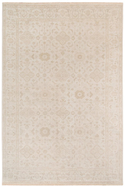 Beige area rug with subtle pattern on a white background