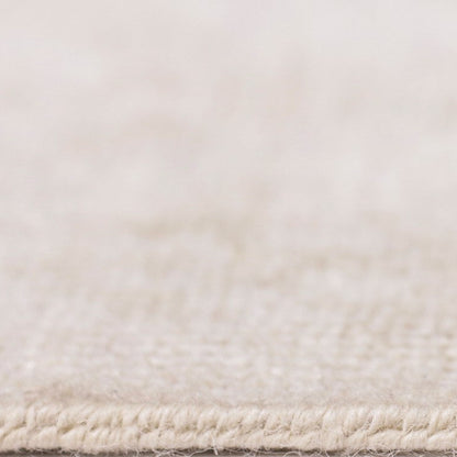Close-up of a textured beige rug corner