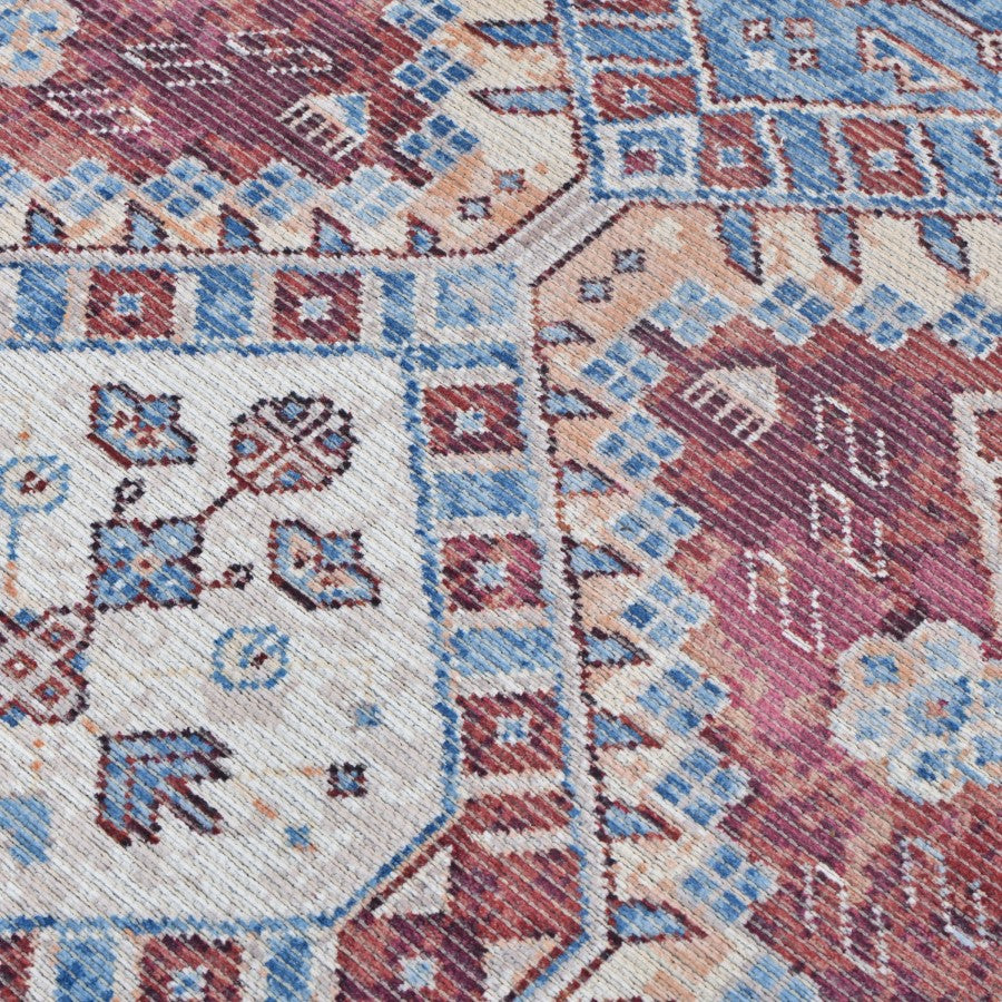 Close-up of a patterned rug with geometric and floral designs.