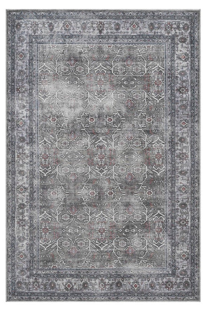 Gray area rug with intricate patterns on a white background