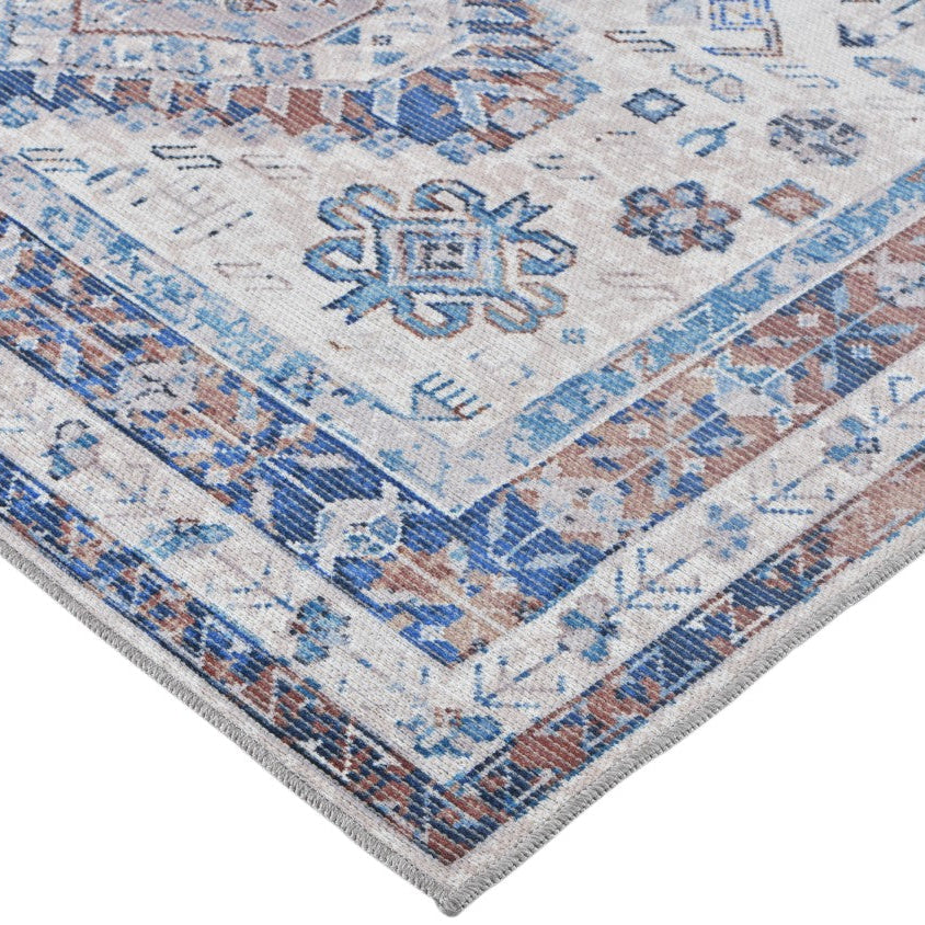 Close-up of a patterned rug with blue and brown colors on a white background