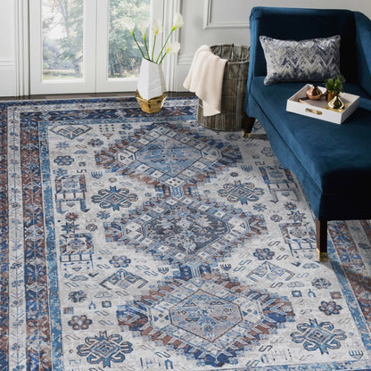 Patterned rug in a living room with a blue sofa and decorative items.