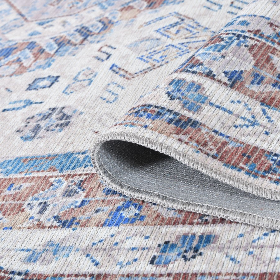 Close-up of a patterned rug with a textured edge