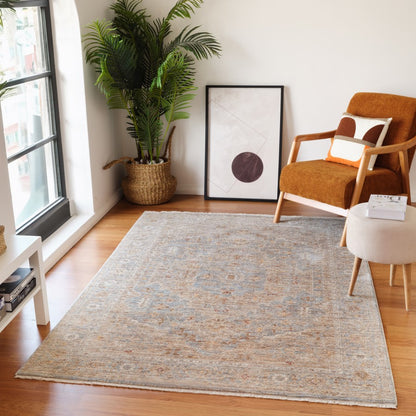 Living room with a large rug, armchair, and plant