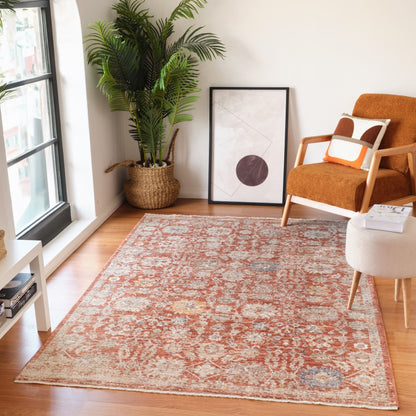 Living room with a patterned rug, armchair, and plant