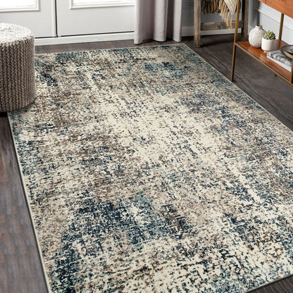 Patterned area rug on a wooden floor with a neutral color scheme