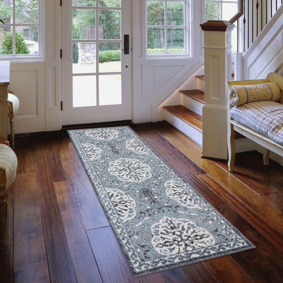 Long decorative rug on a wooden floor in a home interior.