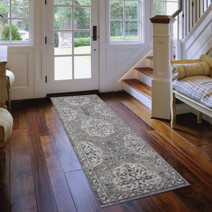 Long decorative rug on a wooden floor in a home interior with a staircase and doors.