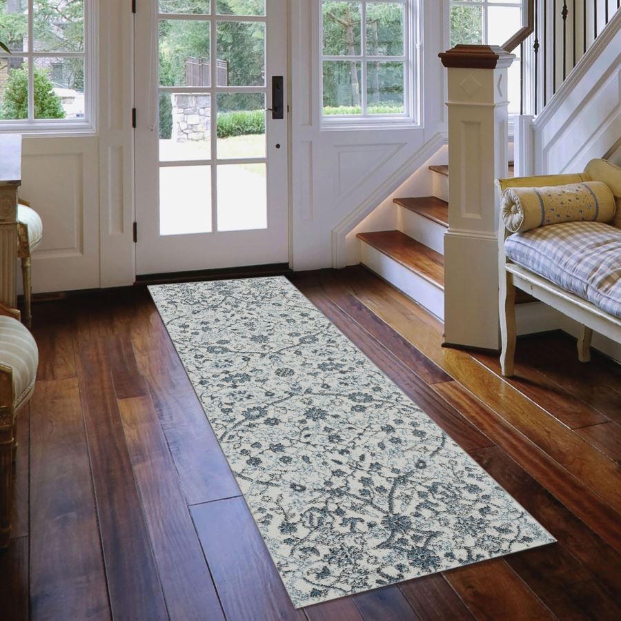 Floral patterned rug on a wooden floor in a home interior.