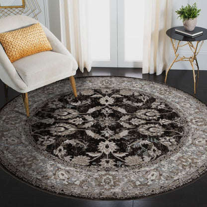 Round patterned rug in a living room setting with a chair and side table.