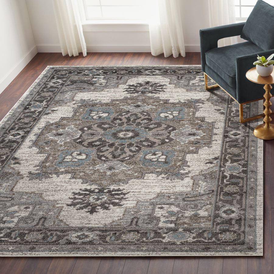 Decorative rug with intricate patterns in a living room setting.
