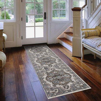 Decorative runner rug on a wooden floor in a home setting with a staircase and doors.