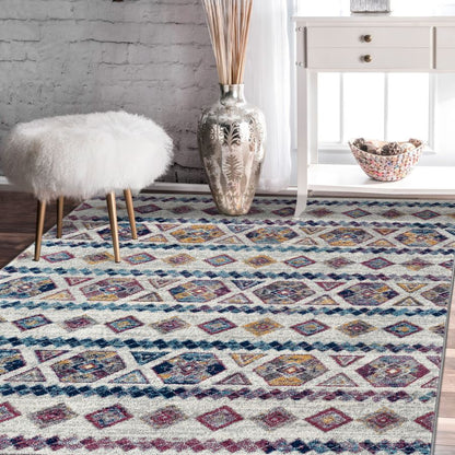 Multicolored patterned rug in a room with a white stool, vase, and basket.
