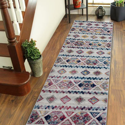 Patterned runner rug on a wooden floor next to a staircase