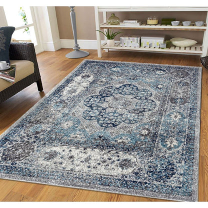 Blue and white patterned rug on a wooden floor in a living room setting.