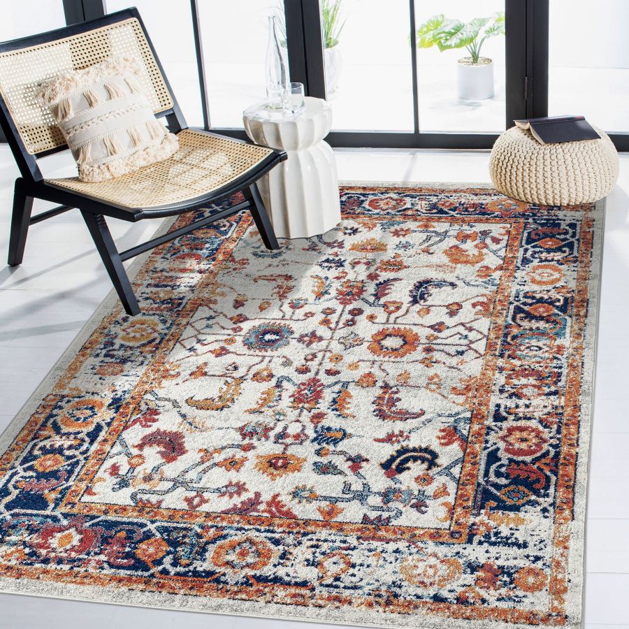 Decorative rug with floral pattern in a room with a chair and table.