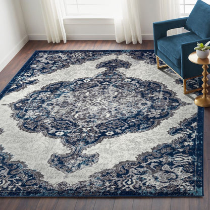 Decorative blue and white area rug in a living room setting with a blue sofa and gold side table.