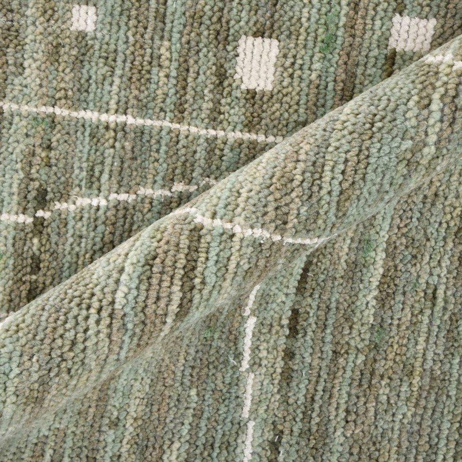 Close-up of textured green carpet with a subtle pattern