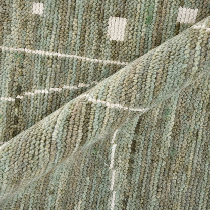 Close-up of textured green carpet with a subtle pattern