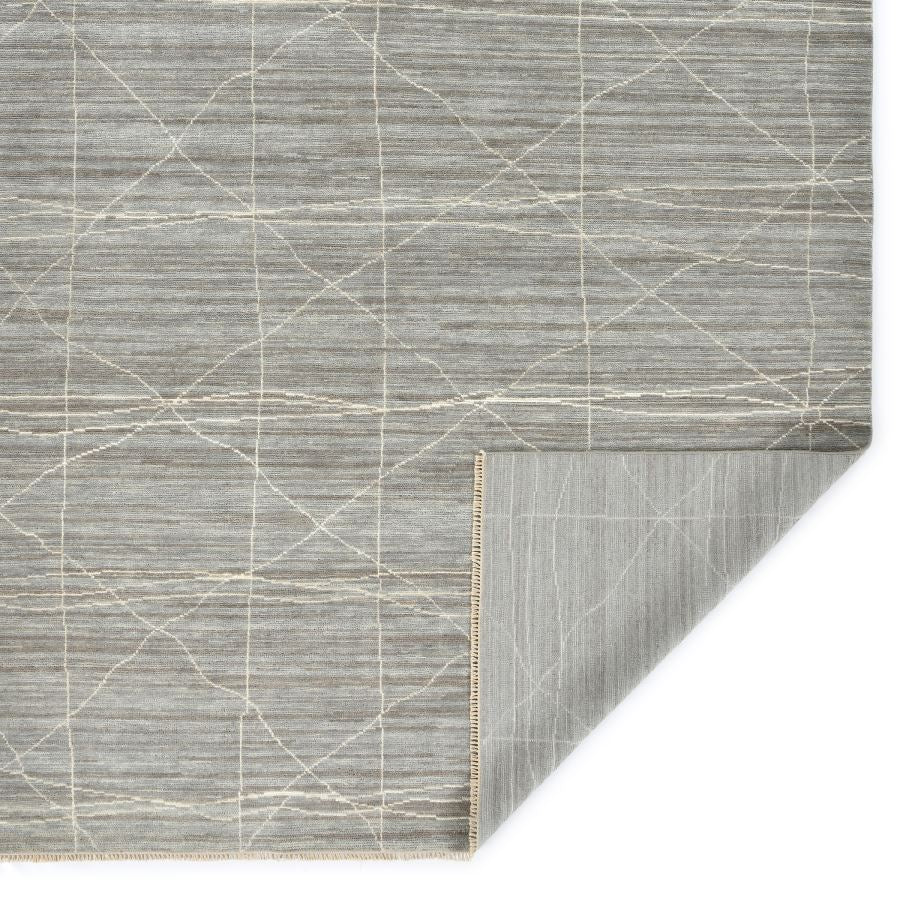 Gray geometric patterned rug on a white background