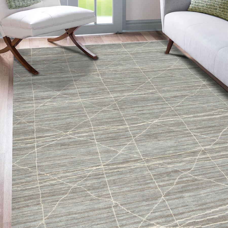 Patterned rug on a wooden floor with chairs and a window in the background