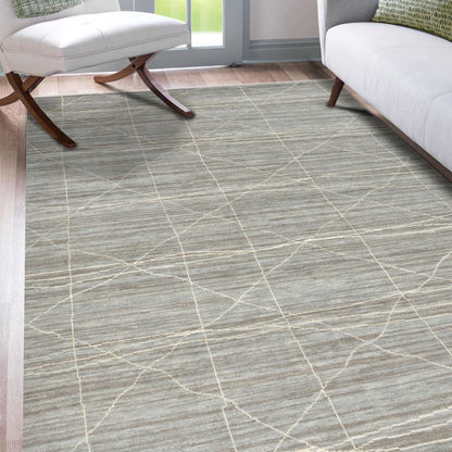 Patterned rug on a wooden floor with chairs and a window in the background
