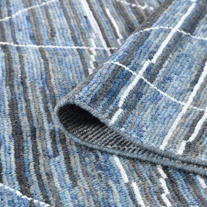 Close-up of a textured blue and gray rug with a grid pattern.