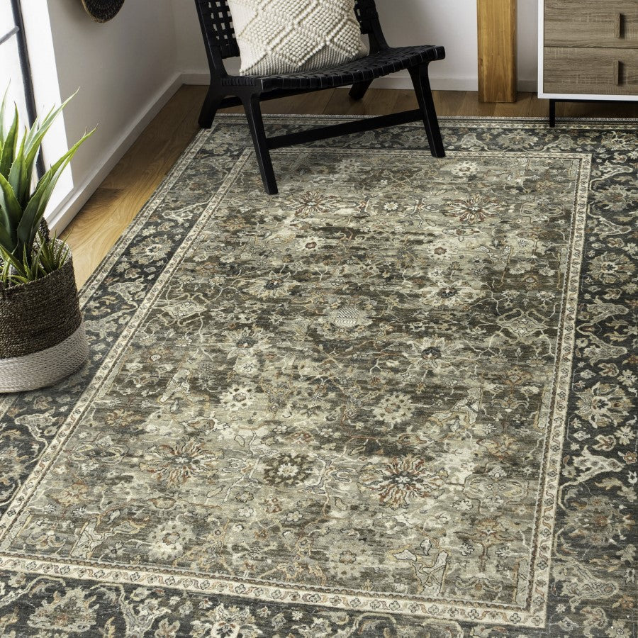 Decorative rug with floral pattern in a room with a chair and plant.