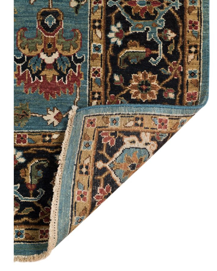 Close-up of a patterned rug corner with intricate designs.