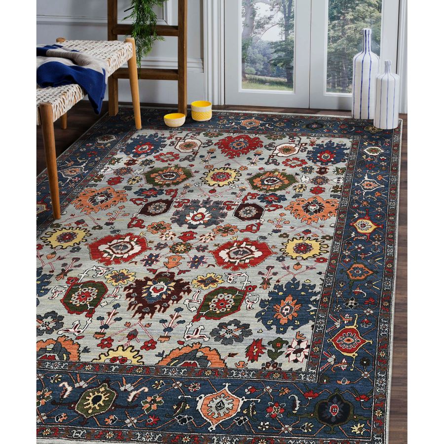 Decorative rug with floral patterns on a wooden floor.