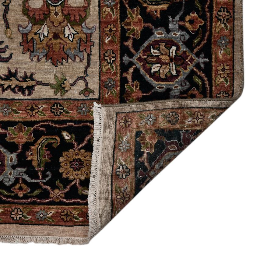 Close-up of a patterned rug corner on a white background