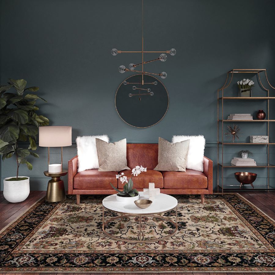Living room with a brown sofa, coffee table, and decorative items against a dark blue wall.