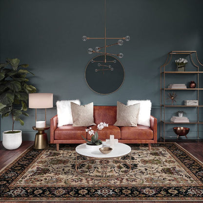 Living room with a brown sofa, coffee table, and decorative items against a dark blue wall.