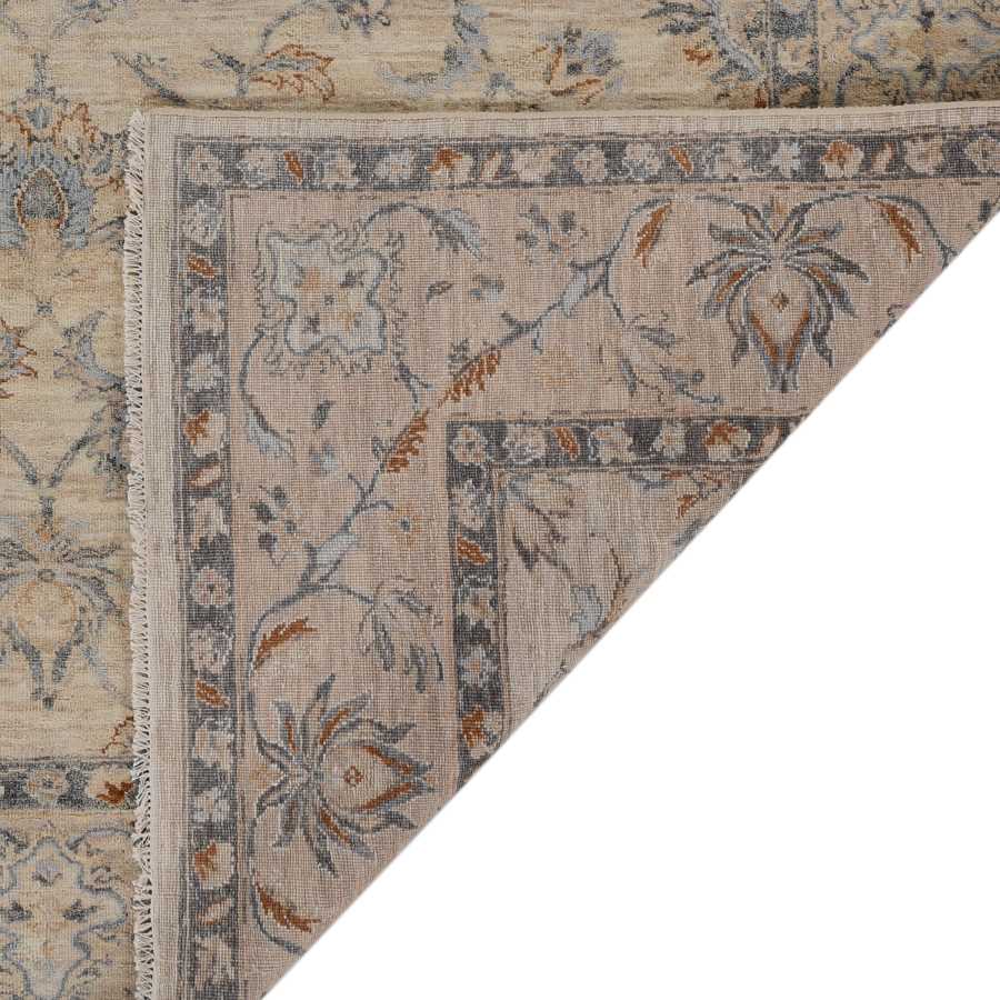 Close-up of a patterned rug with floral designs on a neutral background