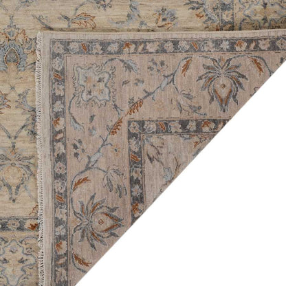 Close-up of a patterned rug with floral designs on a neutral background
