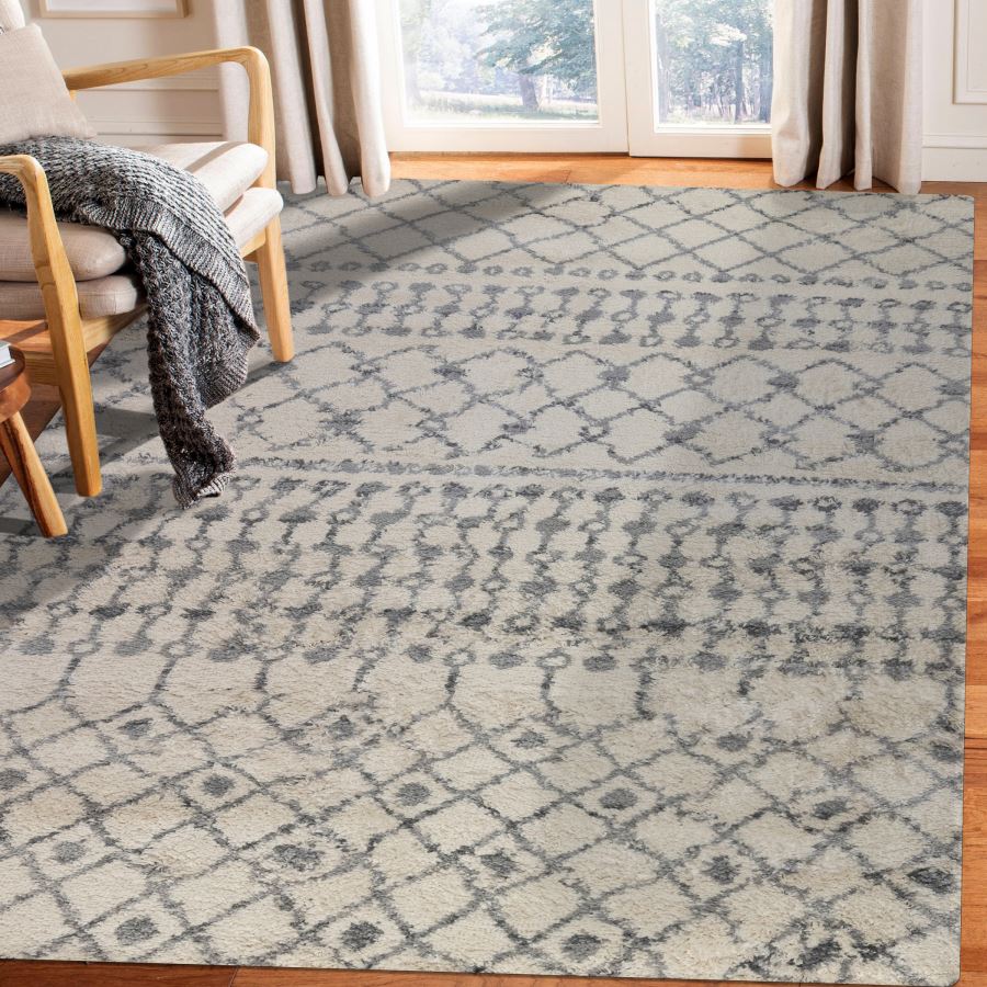 Patterned area rug in a living room with a chair and window in the background