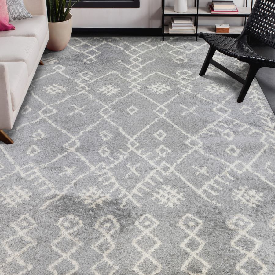 Living room with a gray patterned rug, sofa, and chair.