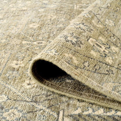 Close-up of a textured beige rug with a rolled edge.