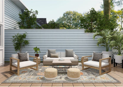 Outdoor patio set with furniture and decor on a wooden deck.