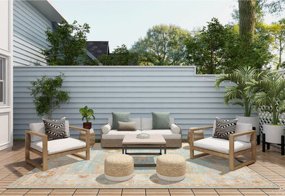 Outdoor patio set with furniture and decor on a wooden deck.