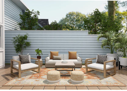 Outdoor patio set with furniture and decor on a wooden deck.